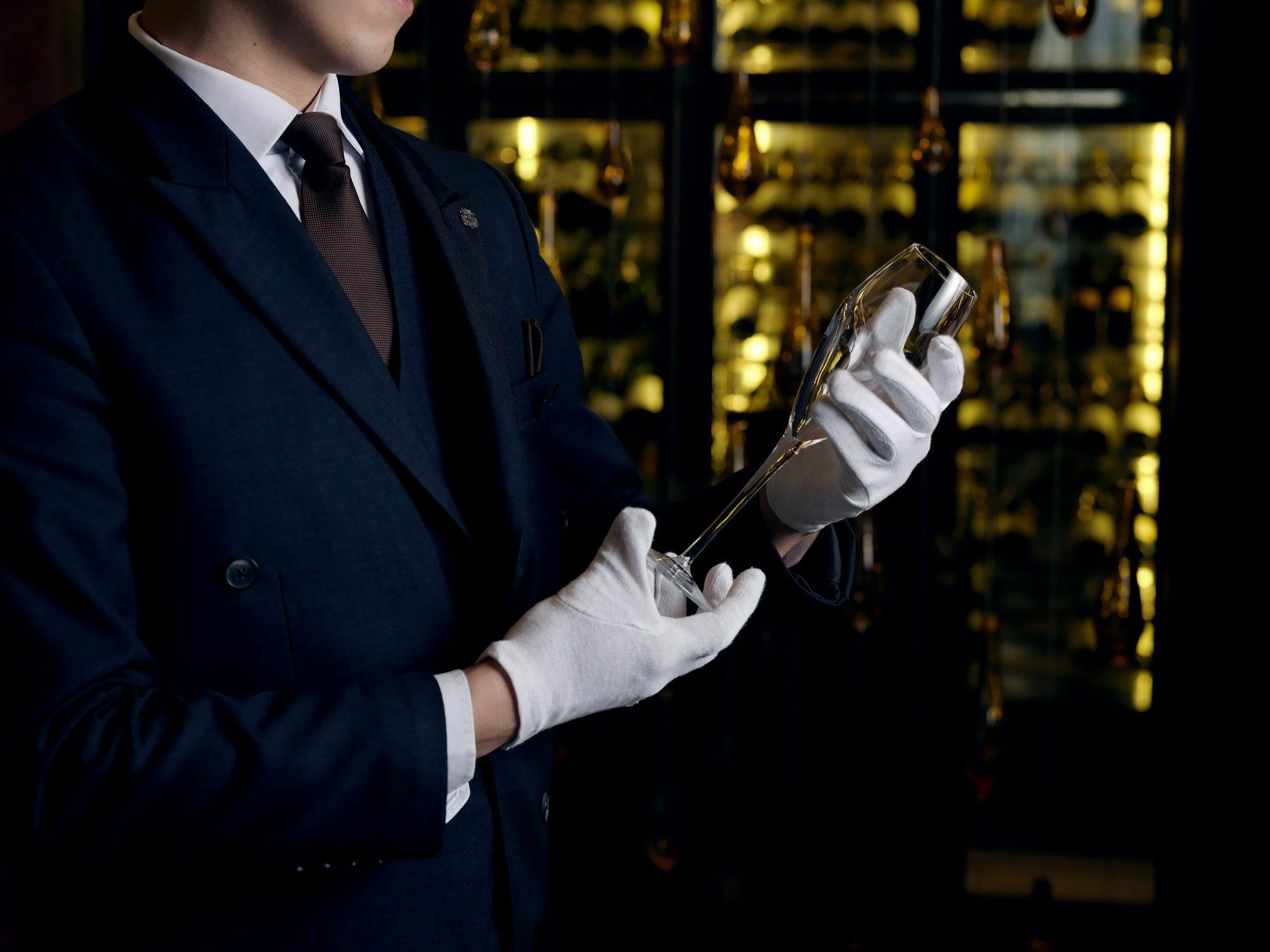 The St. Regis Astana Hotel Luaran gambar A sommelier inspecting a bottle of wine